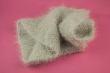 winter knitted scarf front on pink background.