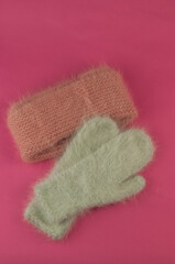 women's winter down mittens on pink background