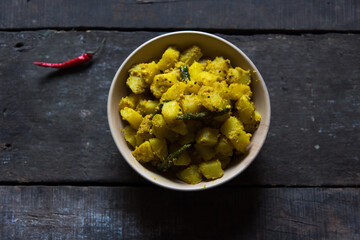 Bengali cuisine aloo posto or potato fried with poppy seeds with a mixture of spices. Close up,...