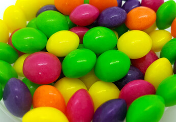 Bright candies in multicolored glaze, close up background