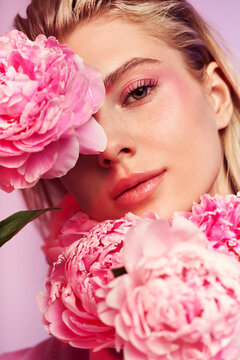 Portrait of woman with pink peony