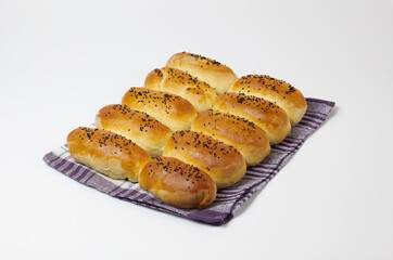 baked, pie goods with black sesame grains on a white background