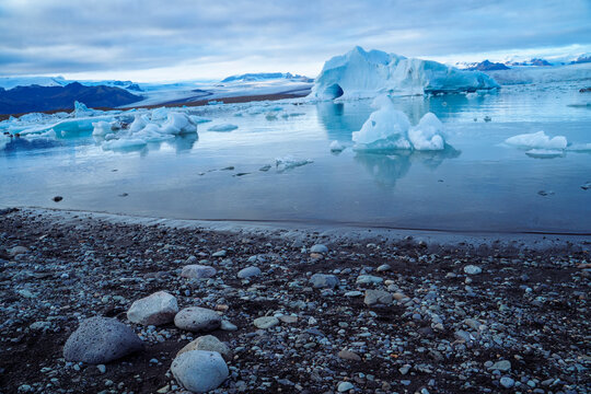 A peaceful scene of icebergs lining up beside the shore of Jokulsarlon, iceland   