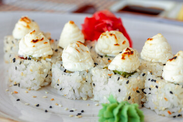 Japanese sushi with sesame seeds and cream icing on gray background