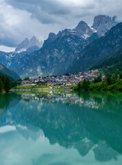 Dolomite mountains reflecting in the Mizurina lake, Italy