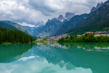 Fototapeta na wymiar Dolomite mountains reflecting in the Mizurina lake, Italy