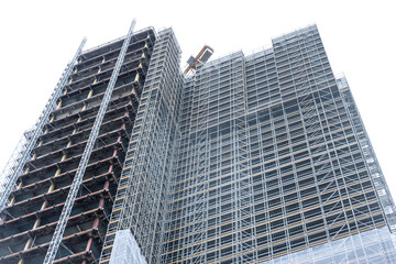 Scaffolding and metallic equipment around a high-rise building construction. No people, day light, outdoors.