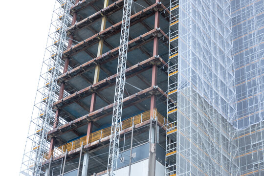 Scaffolding And Metallic Equipment Around A High-rise Building Construction. No People, Day Light, Outdoors.