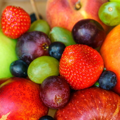 Summer fruit, berry assortment. Big apple, plum, apricot, grape and strawberry. Colorful berries in...