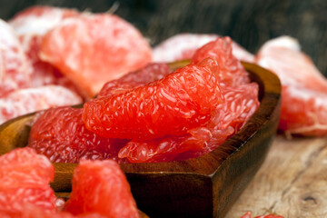 peeled red grapefruit divided into slices