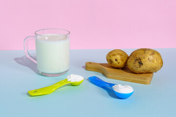 Powdered vegan potato milk. A glass of milk on a multicolored background