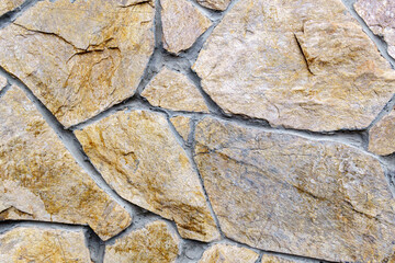 Texture of brown stones laying in pieces. Covering the walls with natural stones
