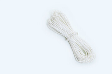 Skein of white household rope on a white background.