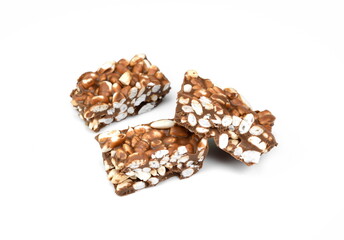 Chunks of milk chocolate with puffed rice isolated on white background. Rice chocolate studio isolated. 