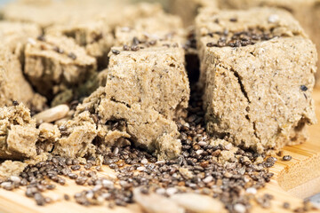 Piece of halva from sunflower seeds. Food, oriental sweetness. Pastry. Selective focus.