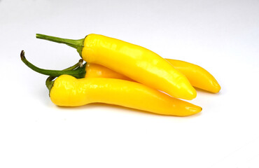 Yellow hot peppers on white background