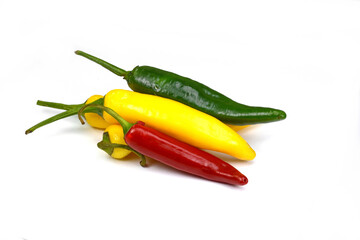 chiili peppers in different colors, yellow, green and red, isolated on white; also know as chilli peppers, chille peppers or just chilli