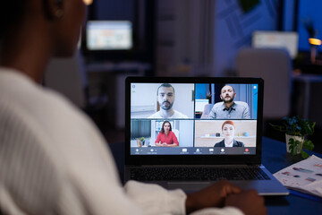 Fototapeta na wymiar Closeup of african american businesswoman discussing marketing ideas planning company strategy with remote team during online videocall meeting conference. Video call telework on laptop screen