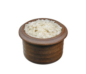 flattened rice flakes in a ceramic bowl isolated on white.