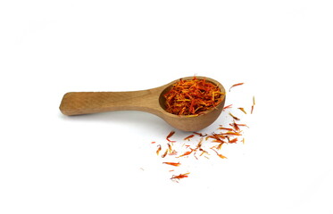 Saffron spice threads (strands) in wooden spoon isolated on white background