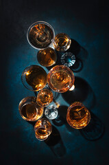 Strong alcohol drinks, hard liquors, spirits and distillates iset in glasses: cognac, scotch,...