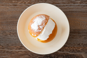 Maritozzo on white plate (Italian dessert)