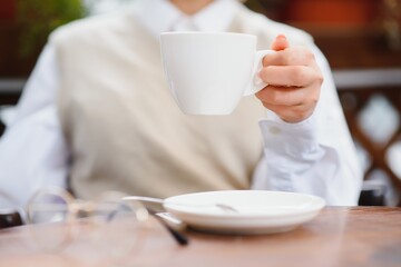 female hands holding a cup of coffee