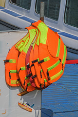 Life jackets hang on the pier of pleasure boats