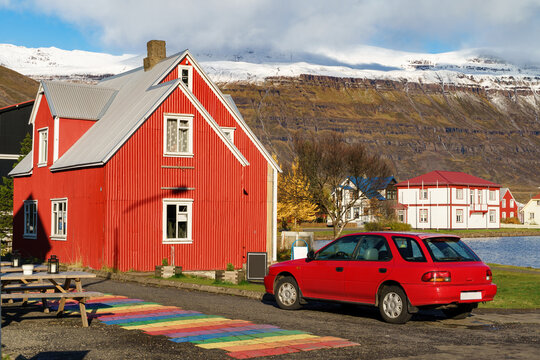Unique vibrant colour of an Icelandic house beside the mountain range -- Seydisfjordur , Iceland