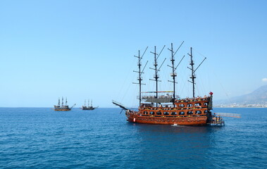 Turkey, Alanya - July 21, 2021: Tourists descend into the sea from the deck of a ship and swim in...