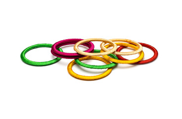 Fototapeta premium Scattered colorful bangles on an isolated white background