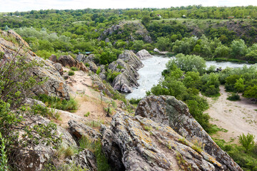 The view from the cliff on Southern Bug river in granite rocks landscape with Integral water rapids in bug Guard national nature park in Mygiya, Mykolaiv Region, Ukraine.