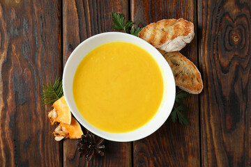 Concept of tasty food with pumpkin soup on wooden table
