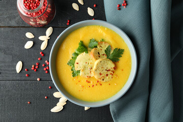 Concept of tasty food with pumpkin soup on wooden table