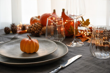 Halloween and Thanksgiving day dinner decorated fallen leaves, pumpkins, spices, grey plate. Close...