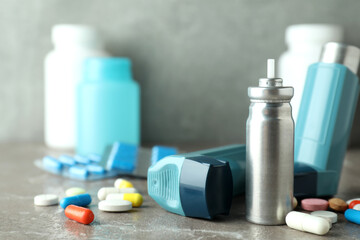 Asthma treatment accessories on gray textured table