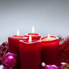 Four red candles for Advent. Christmas background.
