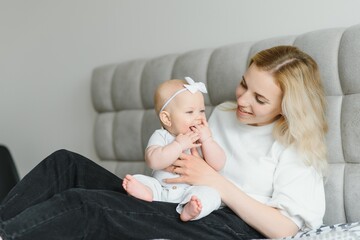 Portrait of mother and child laughing and playing