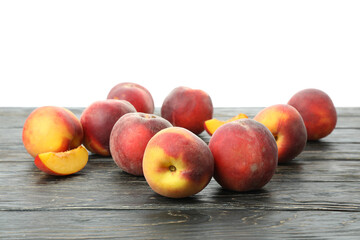 Wooden table with peach fruits isolated on white background