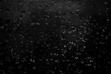 drops of water on a dark glass. Abstract background