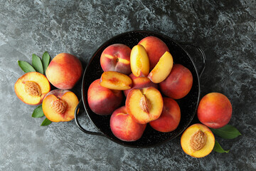 Bowl with peach fruits on black smokey table
