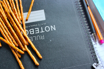 snacks among notebook and pen 