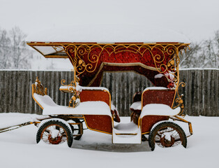 an old red wagon in the snow