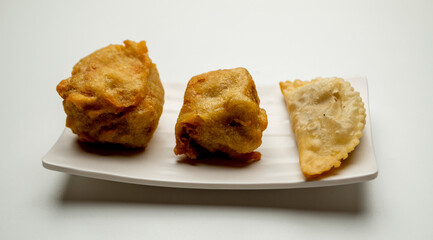 Hot Tofu and Cireng, with part of Gorengan is a typical snack from Indonesia. This food is usually sold by street vendors at cheap prices. Photographed on white plate