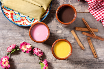 Traditional Mexican atole drink on wooden table