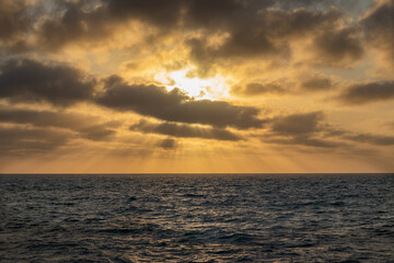 Moody sunset over calm ocean