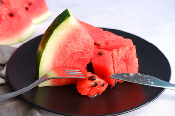 A slice of watermelon on a light blurred background. Berry. The fruit.
