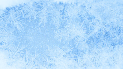 Blue ice with a white pattern of frost and snowflakes. Background. Place for the inscription
