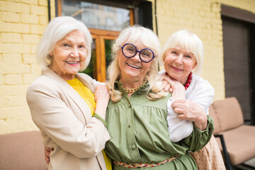 Three ssweet senior ladies looking happy spedning time together