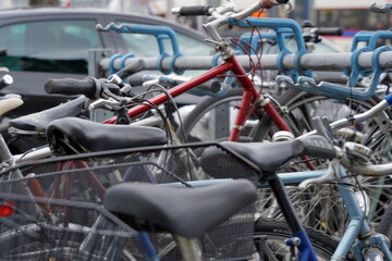 Fototapeta na wymiar Bicycles parked on a busy street with cars. Background picture to mobility or alternative transport in cities. 
